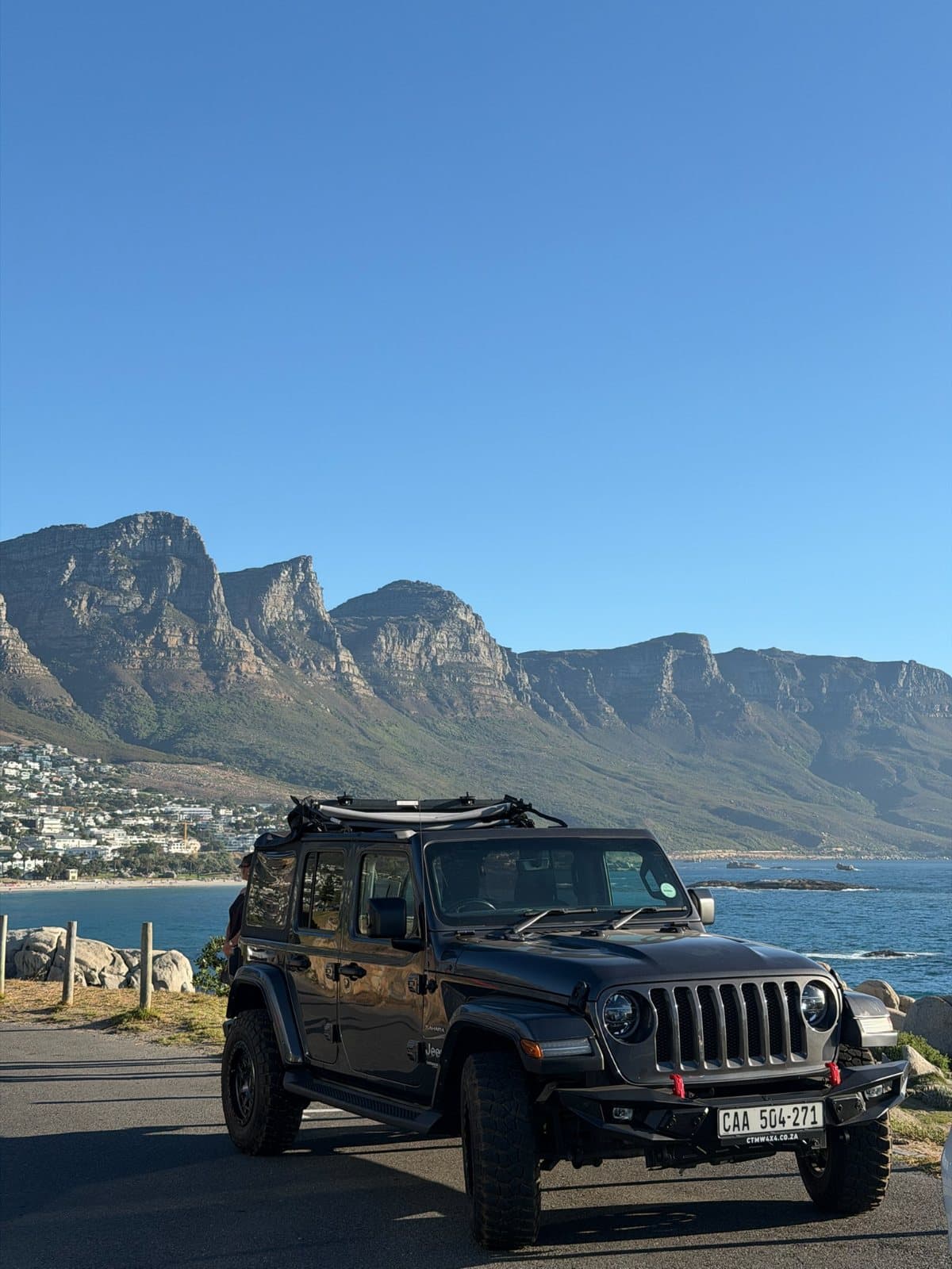 Friends in a jeep on the coast road at Camps Bay