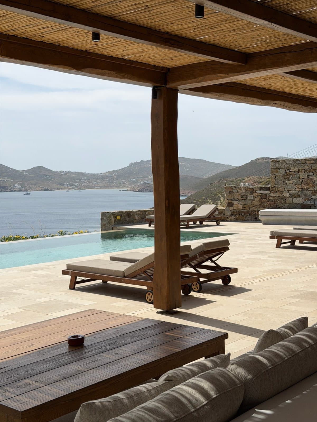 A shaded terrace and pool above the bay